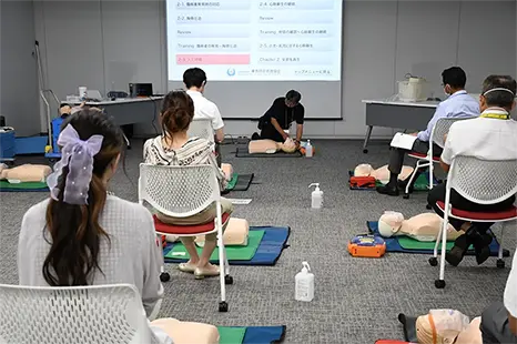 An instructor demonstrates lifesaving techniques using a dummy.